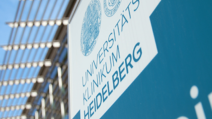 Photo d&rsquo;un manipulateur qui configure une acquisition sur le statif du scanner, avec le patient sur la table d&rsquo;examen